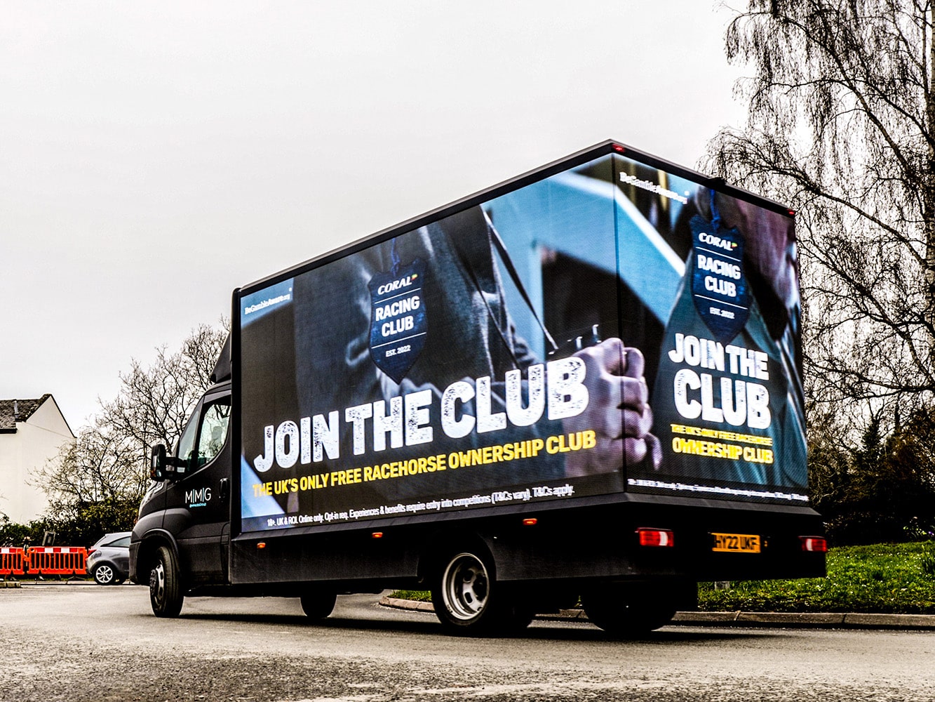 A digital advertising van with Coral on the screen.