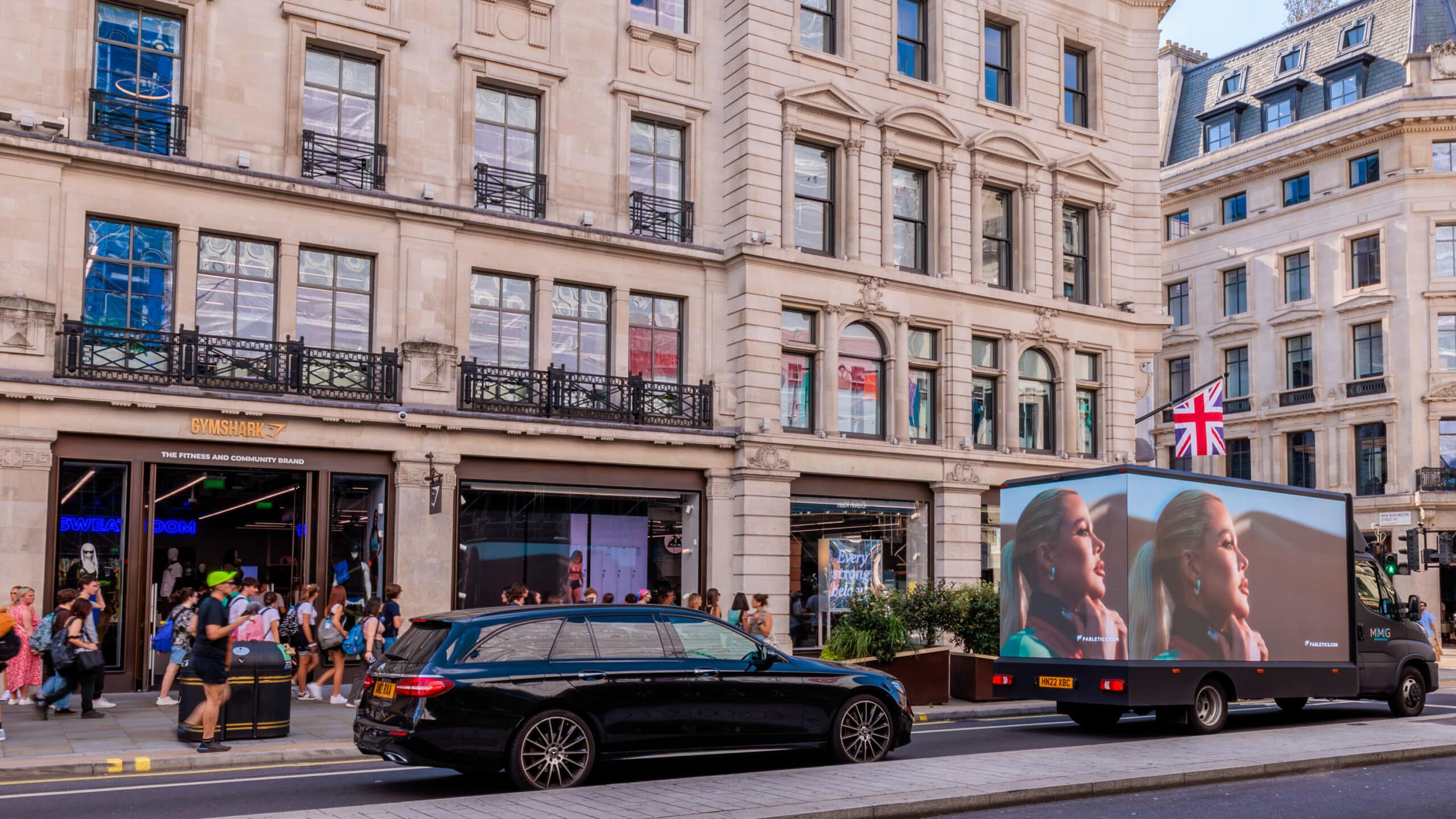 Fabletics Edge Digivan competitor targeting outside of a Gym Shark store.