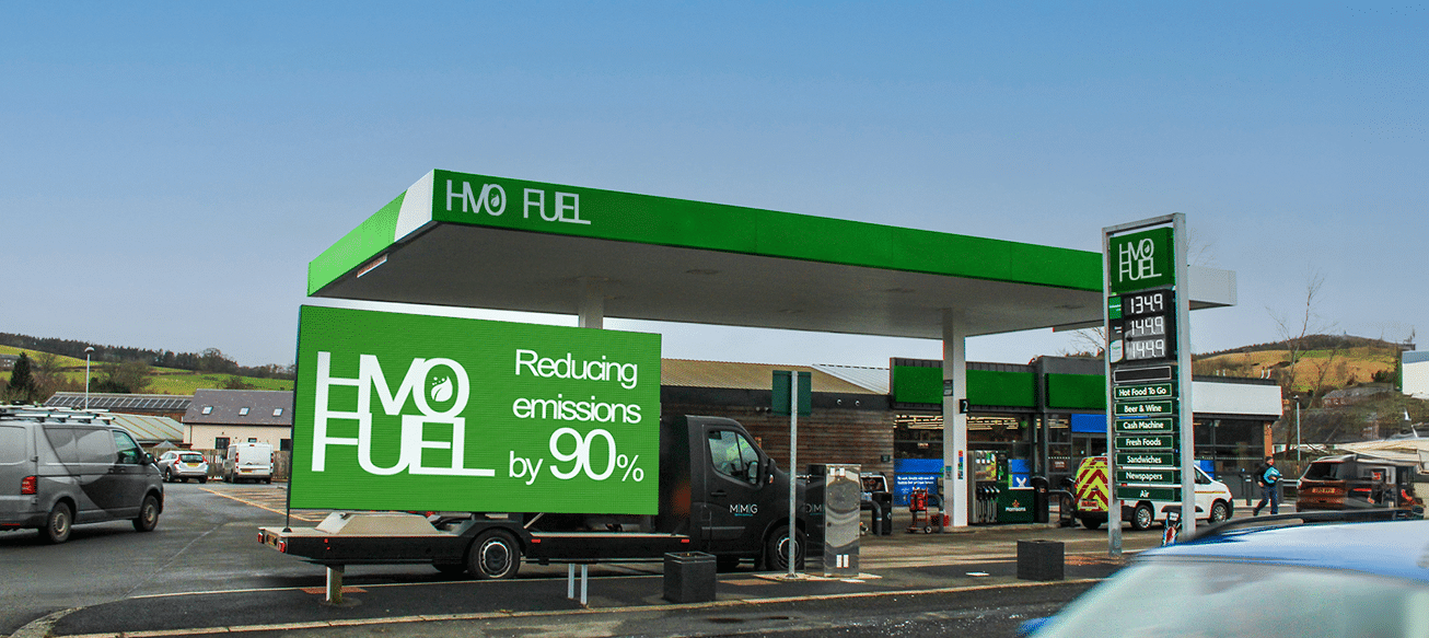 Out of home Digivan refuelling at renewable HVO station, with the advertising van's LED screen displaying the message "HVO fuel reducing emissions by 90%".